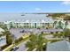 Lovely aerial view of the condos, with a backdrop of beautiful bay waters and parking spaces at 464 N Paula Dr # 322, Dunedin, FL 34698