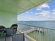 Serene balcony setup with chairs offering a tranquil water view and comfortable outdoor space at 464 N Paula Dr # 322, Dunedin, FL 34698