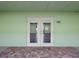 Inviting clubhouse double-door entrance with beautiful brick flooring, for events and gatherings at 464 N Paula Dr # 322, Dunedin, FL 34698