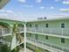 Exterior facade of the building with multiple levels and an open-air walkway at 464 N Paula Dr # 322, Dunedin, FL 34698