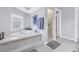 Elegant bathroom with corner bathtub, shower, and window at 5264 61St S Ave, St Petersburg, FL 33715