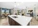 Modern kitchen with island and open concept to dining area at 8409 Dove Bog Ter, Parrish, FL 34219