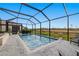 Relaxing screened-in pool with a view of the natural landscape at 8409 Dove Bog Ter, Parrish, FL 34219