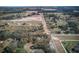 Aerial lot view of property, wooded area, and nearby homes at 10019 Curley Rd, San Antonio, FL 33576