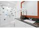 Bright bathroom featuring a granite countertop, updated cabinets and a walk-in shower at 10106 Radcliffe Dr, Tampa, FL 33626