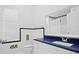 Bright bathroom featuring a quartz countertop and patterned tile at 10106 Radcliffe Dr, Tampa, FL 33626