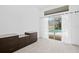 Bright bedroom featuring plush carpet, custom built-ins and sliding glass doors to the screened in patio at 10106 Radcliffe Dr, Tampa, FL 33626