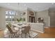 Elegant dining room with large windows, decorative chandelier, and seating for six at 10106 Radcliffe Dr, Tampa, FL 33626