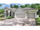 Beautiful home exterior features a two-car garage, paved driveway, manicured landscaping, and a tile roof at 10106 Radcliffe Dr, Tampa, FL 33626
