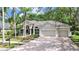 Charming single Gathering home with mature landscaping, three car garage, and a brick paver driveway at 10106 Radcliffe Dr, Tampa, FL 33626