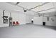 Spacious garage features epoxy floors, storage cabinets, utility sink, and water heater at 10106 Radcliffe Dr, Tampa, FL 33626