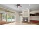Open living room with fireplace and sliding glass doors leading to pool at 10106 Radcliffe Dr, Tampa, FL 33626