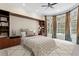 Spacious main bedroom featuring an oversized window with pool views, custom built-ins and a cozy seating area at 10106 Radcliffe Dr, Tampa, FL 33626