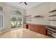 Bright office space with hardwood floors, built-in desk, floating shelves, and large windows for natural light at 10106 Radcliffe Dr, Tampa, FL 33626