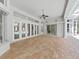 Covered outdoor living space with brick flooring and large sliding glass doors at 10106 Radcliffe Dr, Tampa, FL 33626
