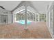 Covered patio with brick floor, columns, and view of pool at 10106 Radcliffe Dr, Tampa, FL 33626