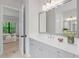 Bright bathroom featuring a quartz countertop, modern vanity, and a view of the bedroom, blending comfort with elegance at 10639 Ruffino Ct, Trinity, FL 34655