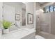 Stylish bathroom featuring a large mirror, modern vanity, and glass-enclosed shower at 10639 Ruffino Ct, Trinity, FL 34655