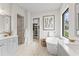 Elegant bathroom features a soaking tub, a walk-in shower, and dual vanities, creating a spa-like oasis for relaxation at 10639 Ruffino Ct, Trinity, FL 34655