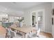 Airy dining space with a rustic wooden table, stylish seating, and views of the adjacent living areas at 10639 Ruffino Ct, Trinity, FL 34655