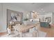 Elegant dining space features a large painting, seating for six, and an adjacent view of the gourmet kitchen at 10639 Ruffino Ct, Trinity, FL 34655