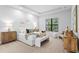 Serene main bedroom with neutral tones, a large window, and elegant furnishings, creating a relaxing and inviting retreat at 10639 Ruffino Ct, Trinity, FL 34655
