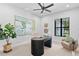 Stylish office features modern decor, a sleek desk, and a large window, creating a functional and aesthetically pleasing workspace at 10639 Ruffino Ct, Trinity, FL 34655