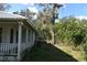 Side view of the house with a porch and a hot tub at 11245 Fort King Rd, Dade City, FL 33525