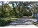 Long driveway leading to home, surrounded by lush landscaping at 11245 Fort King Rd, Dade City, FL 33525