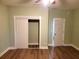 Neutral bedroom with wood-look flooring, white trim, and closet at 143 44Th N Ave, St Petersburg, FL 33703