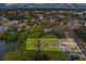 Aerial view of fire-damaged house on a lot near a lake at 15364 Newport Rd, Clearwater, FL 33764