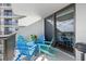 Relaxing balcony with blue patio chairs and table, offering water views at 1660 Gulf Blvd # 706, Clearwater Beach, FL 33767