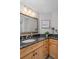 Bathroom featuring granite countertop and wood cabinets at 1660 Gulf Blvd # 706, Clearwater Beach, FL 33767
