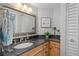 Bathroom with granite vanity, wood cabinets, and a large mirror at 1660 Gulf Blvd # 706, Clearwater Beach, FL 33767