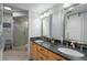 Large bathroom with granite double vanity and walk-in shower at 1660 Gulf Blvd # 706, Clearwater Beach, FL 33767