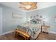 Bedroom with ceiling fan, wooden bench, and light walls at 1660 Gulf Blvd # 706, Clearwater Beach, FL 33767