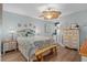 Bedroom with a ceiling fan, wooden dresser, and bedding at 1660 Gulf Blvd # 706, Clearwater Beach, FL 33767