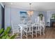 Elegant dining room with white table and chandelier at 1660 Gulf Blvd # 706, Clearwater Beach, FL 33767