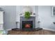 Modern electric fireplace with granite surround, adds warmth to living space at 1660 Gulf Blvd # 706, Clearwater Beach, FL 33767