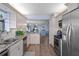 Open concept kitchen with granite counters, stainless steel appliances, and hardwood floors at 1660 Gulf Blvd # 706, Clearwater Beach, FL 33767