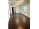 Spacious living room with dark hardwood floors at 18415 Geraldine Rd, Dade City, FL 33523