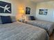 Guest bedroom with two twin beds and coastal decor at 19418 Gulf Blvd # 506, Indian Shores, FL 33785