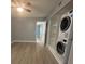 Bedroom with wood-look floors, ceiling fan and washer/dryer at 2460 Canadian Way # 6, Clearwater, FL 33763