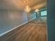 Bright living room featuring hardwood floors and a large mirror at 2460 Canadian Way # 6, Clearwater, FL 33763