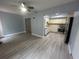 Open living room and kitchen with wood-look floors at 2460 Canadian Way # 6, Clearwater, FL 33763