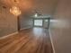 Spacious living room with hardwood floors and a chandelier at 2460 Canadian Way # 6, Clearwater, FL 33763
