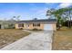 Single story home with a long driveway and spacious yard at 289 Killinger Ave, Spring Hill, FL 34606