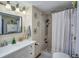 Well-lit bathroom featuring a single vanity, framed mirror, and a shower with a shower curtain at 3717 46Th S Ave # 6, St Petersburg, FL 33711