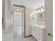 Bright bathroom featuring tiled floors, a classic vanity, and a view into the adjacent room at 3717 46Th S Ave # 6, St Petersburg, FL 33711
