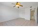 Neutral bedroom with tile flooring, ceiling fan, closet and open bathroom access at 3717 46Th S Ave # 6, St Petersburg, FL 33711